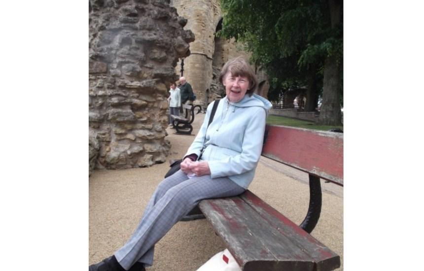 Sue's mum sitting on a bench during a day trip