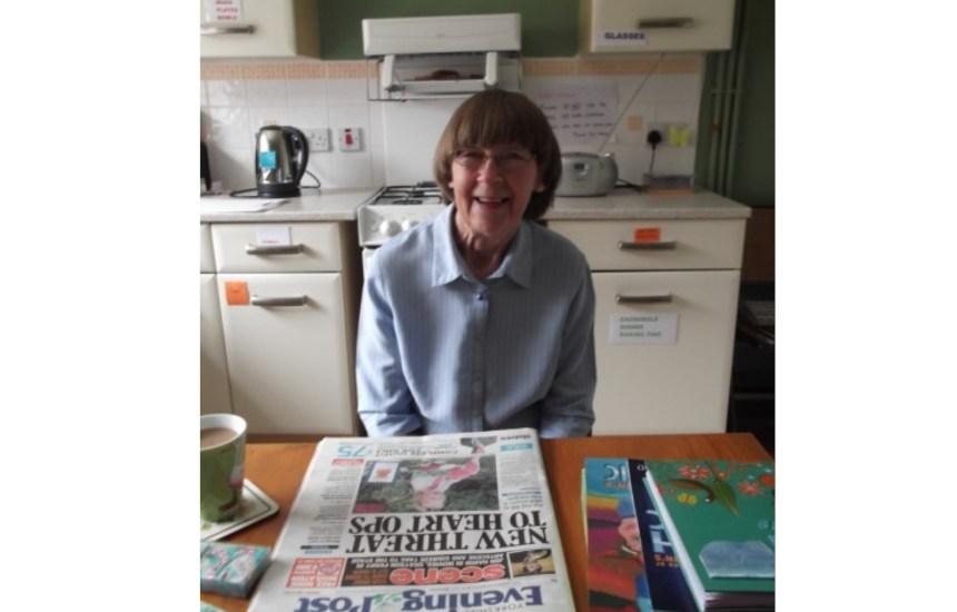 Sue's mum with her newspaper and books