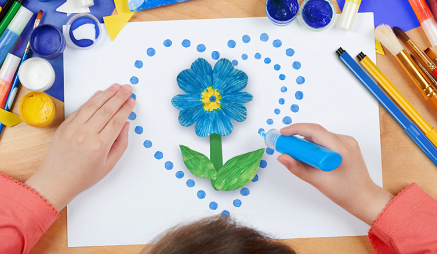 A child creating a forget me not craft