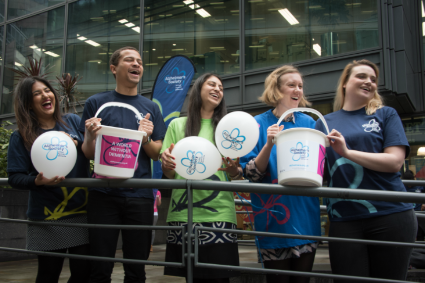 Alzheimer's Society fundraisers with donation buckets