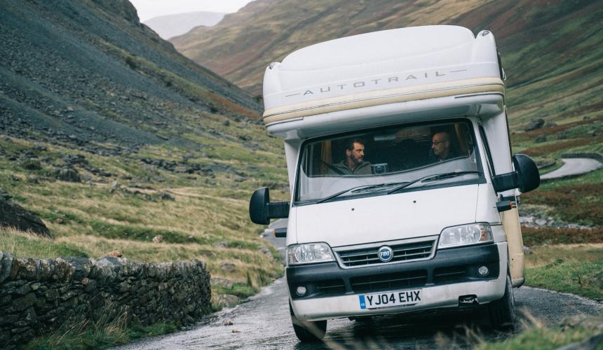 Actors Colin Firth and Stanley Tucci driving a campervan during the film Supernova