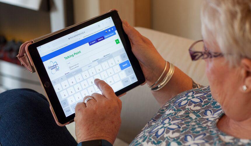 A woman uses Talking Point on a tablet device