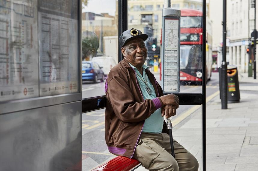 A man sitting at a bus stop