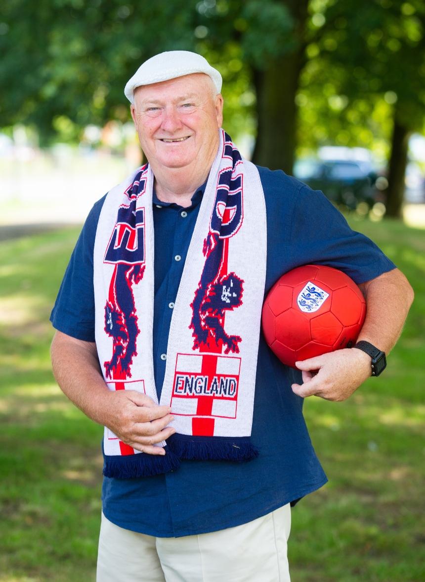 Tommy Dunne, wearing an England scarf and holding a football