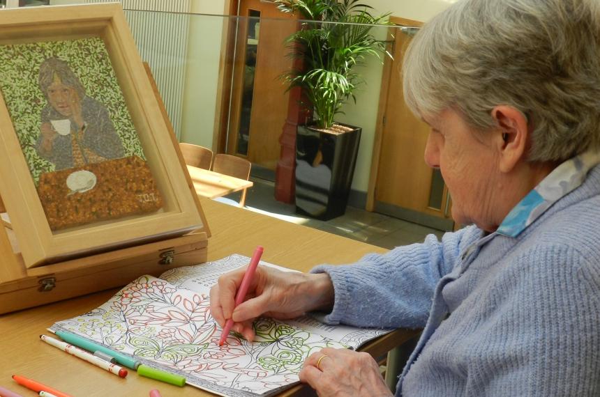 James' grandmother Joan colouring a page of her activity book