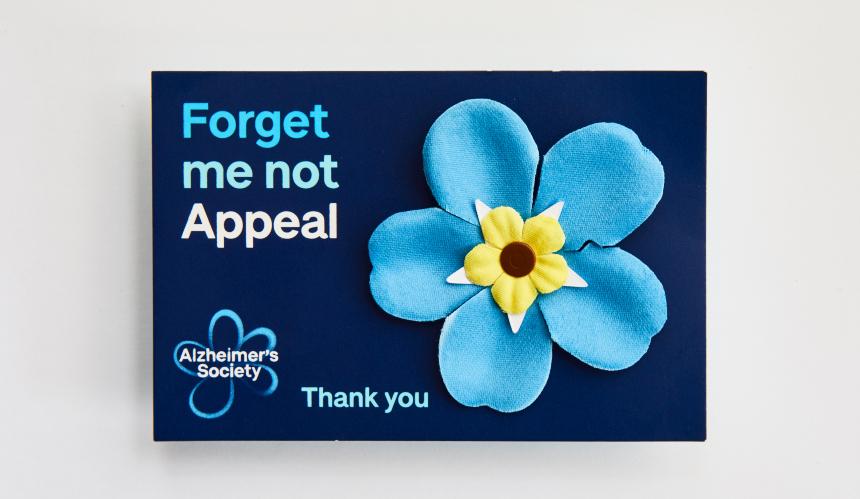 Forget Me Not Appeal flower badge on a card that says 'thank you'