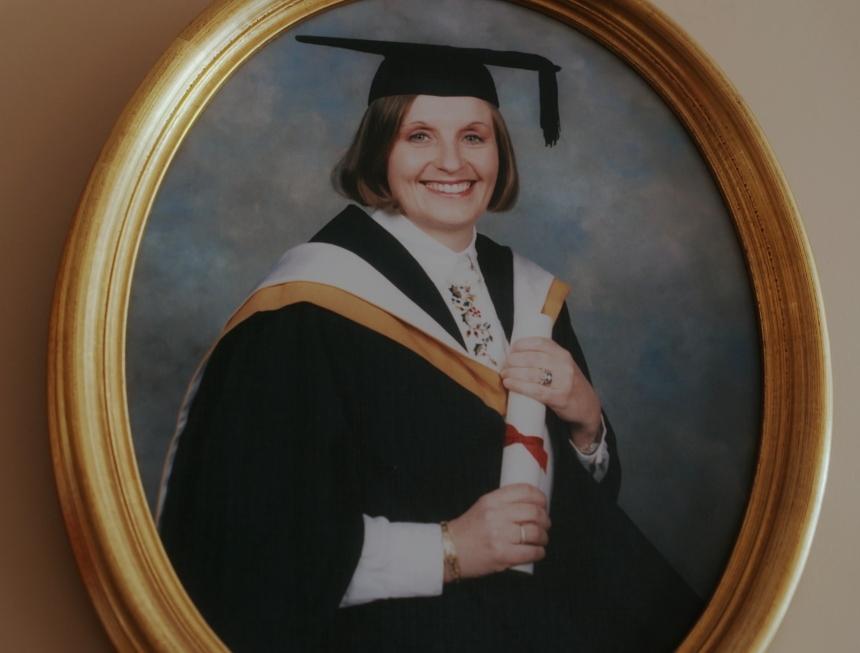 A photo of a framed picture of Jo at her graduation