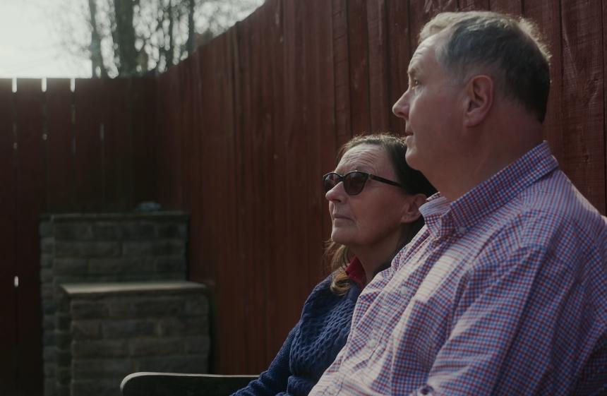 Jo and Bill sat in their garden, looking into the distance