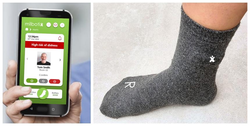 A smartphone displaying the app and a person's foot wearing a grey sock with white logos on them