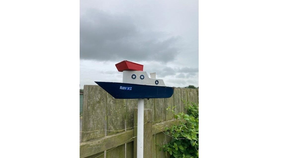 A birdhouse in the shape of a boat