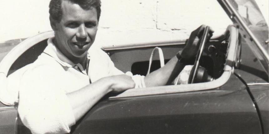 An old photograph of Robert Davis in a sports car