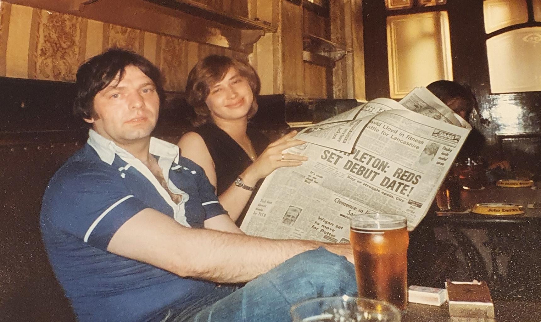 An old photograph of Candy and Stan in the pub reading the sports section of the Manchester Evening News