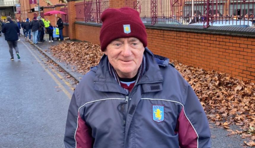 Peter wearing an Aston Villa coat and hat on an Autumn day, and smiling