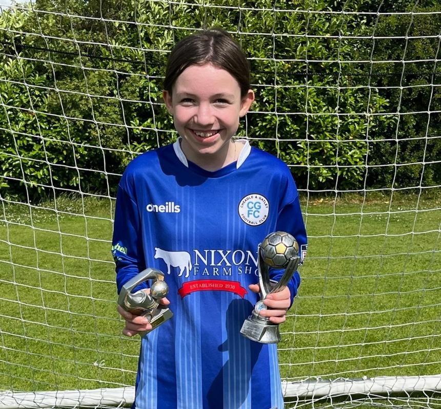 Stan and Candy's grand daughter, Freya, pictured in her football kit holding a trophy