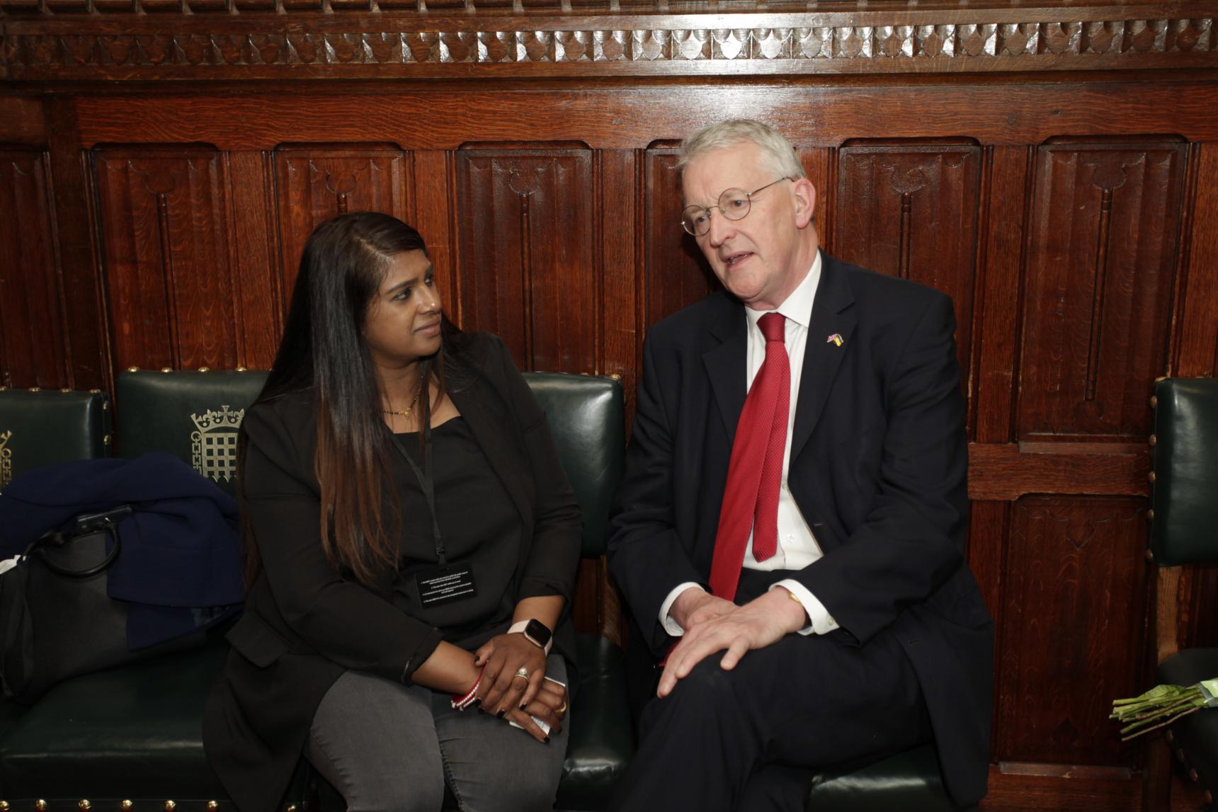 Alzheimer's Society campaigner Versha speaks with Hilary Benn MP at a parliamentary event for Dementia Action Week