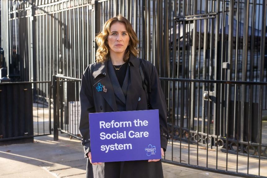 Vicky McClure holds up a sign that says 'Reform the Social Care system' outside the gates of Downing Street, London.