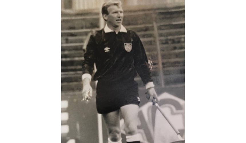 An old photograph of Peter Jones as a referee on a football pitch