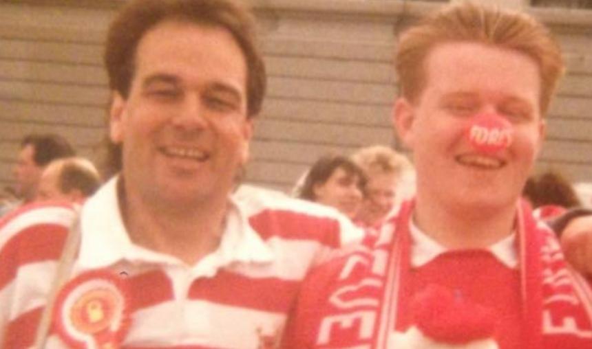 Paul and his dad are arm in arm and dressed with full Nottingham Forest merch