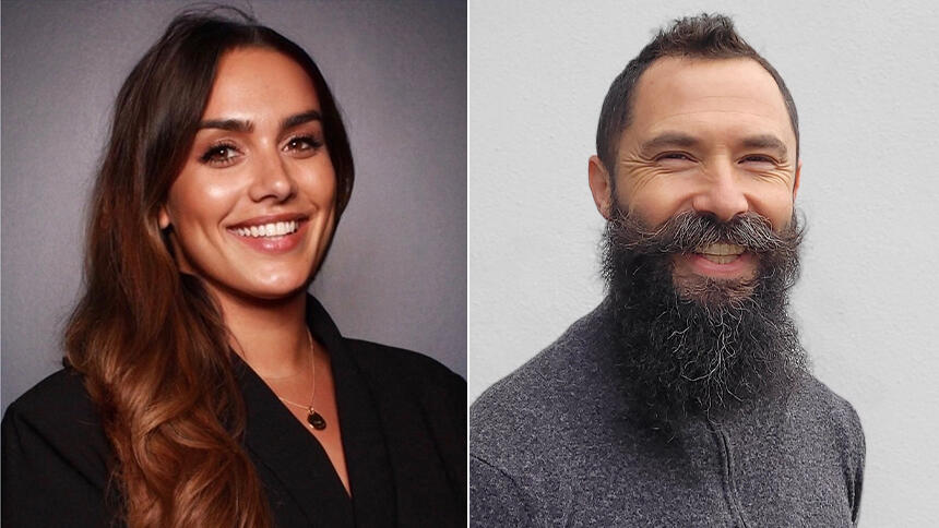 A woman with long brown hair wearing a black top and a man with short grey hair and bushy beard wearing a grey jumper