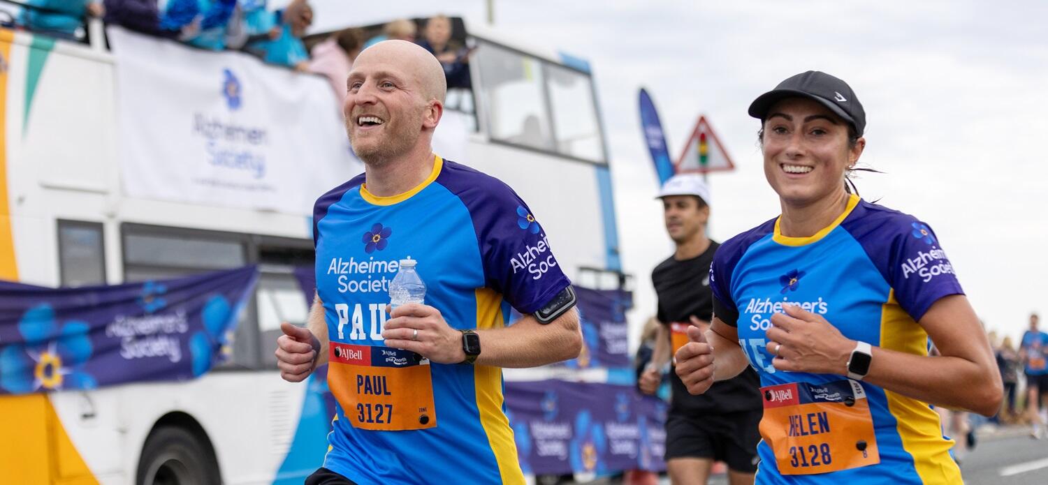 Two Alzheimer's Society runners taking part in a race