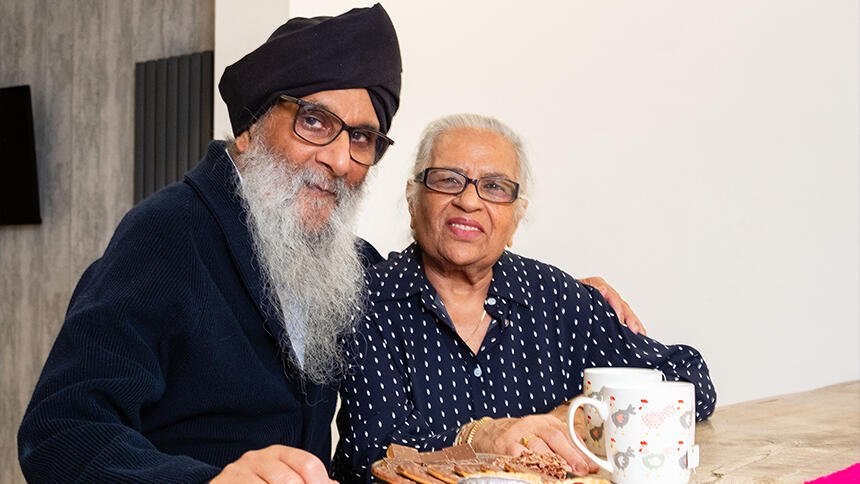 Harjit Singh Sagu sat at a table with his wife