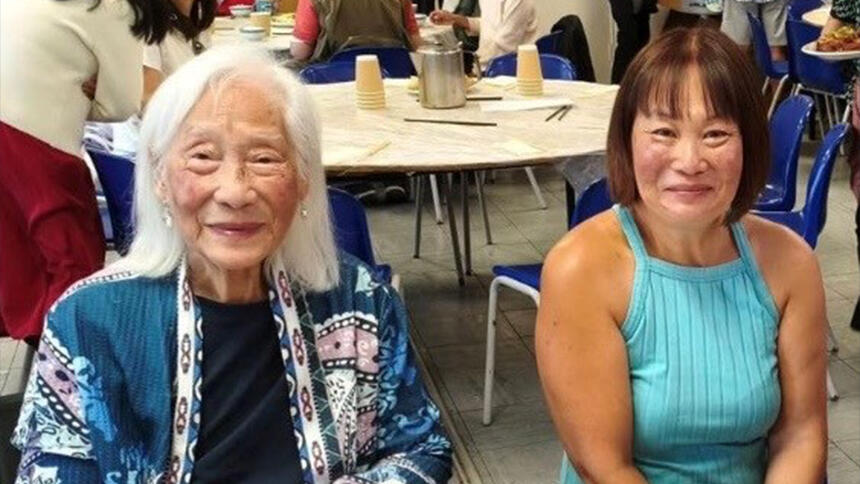 Annie Chinfen sitting with her daughter Rachel at a community centre event