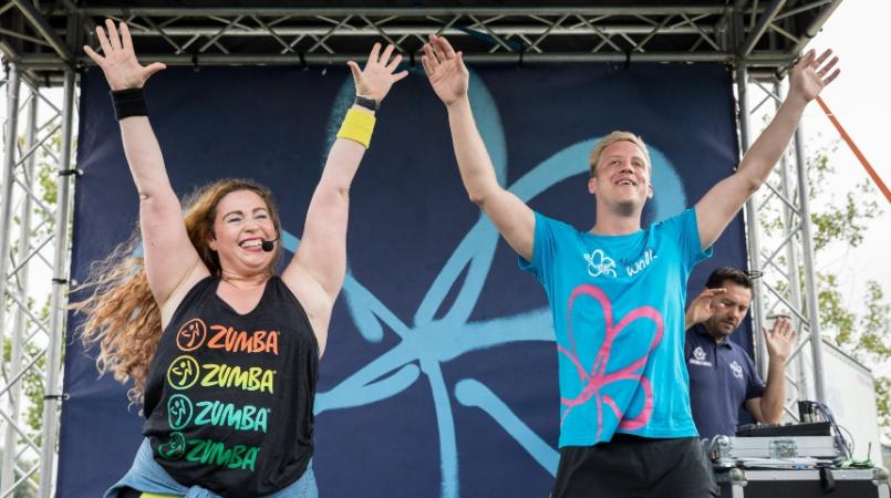 Gareth on stage with a zumba instructor at Memory Walk