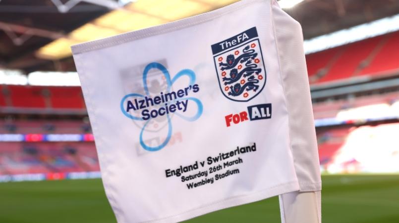 A flag waving with the Alzheimer's Society logo and FA logo