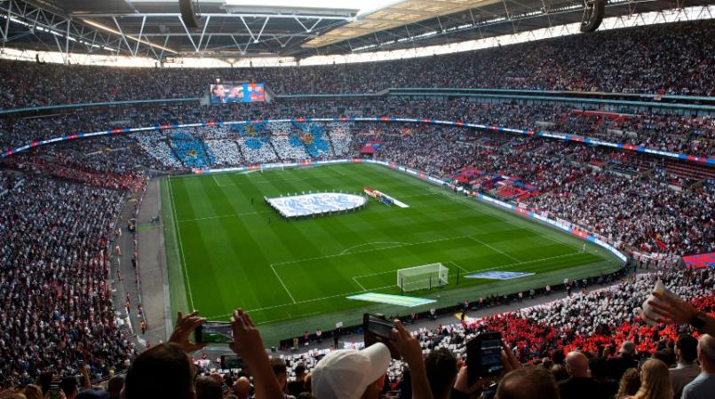 A picture of Wembley stadium with the Alzheimer's Society logo in the stands
