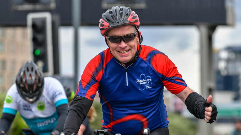 Thumbs up, man cycling at Ride London 2022