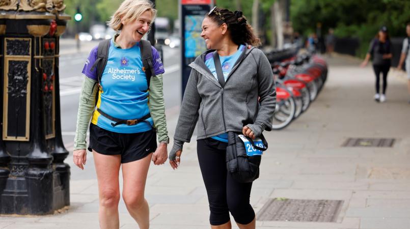 2 ladies smiling and chatting whilst trekking in London