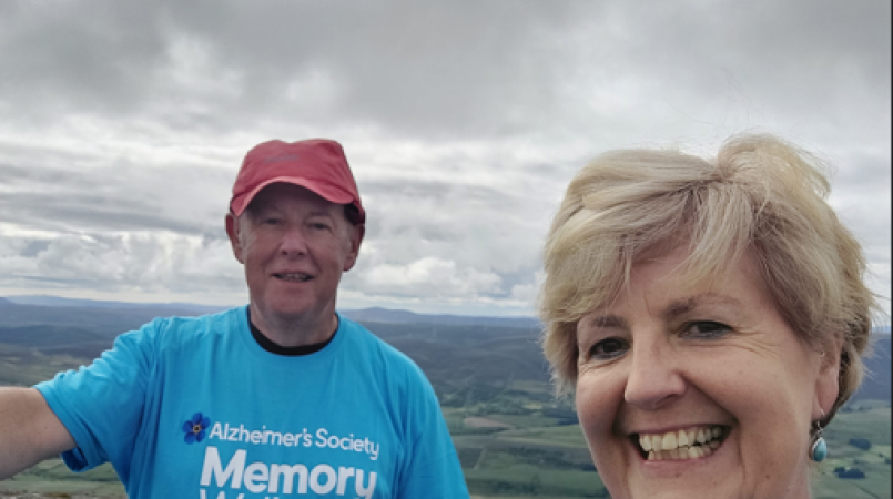 2 people wearing blue Memory Walk t-shirts smiling at the camera