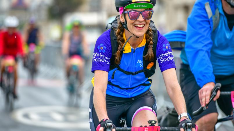 Lady cycling and smiling