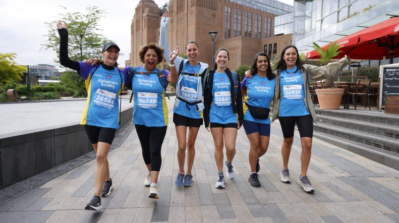 Group of people walking in front of Battersea power station.