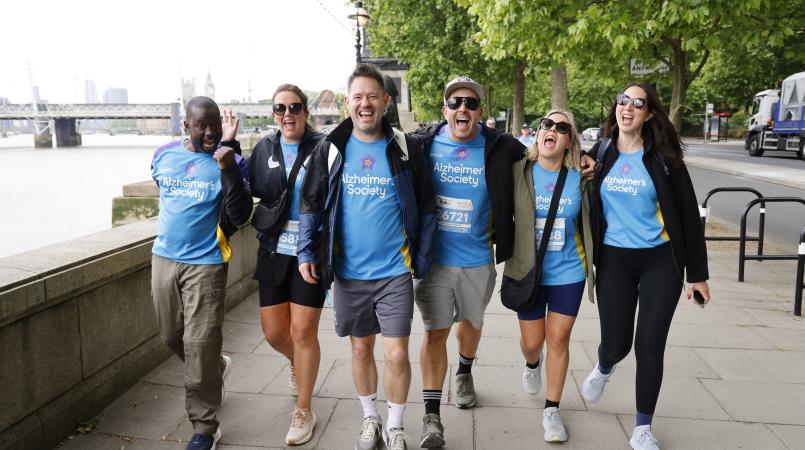 Group of people walking along the London south bank.