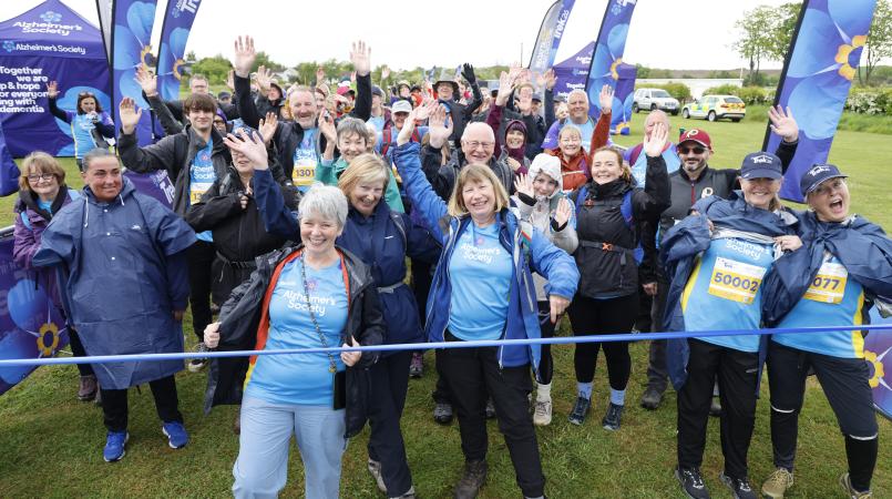 A group of people cheering at a start line.