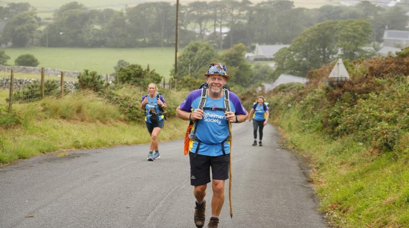 Man walking on the road smiling.