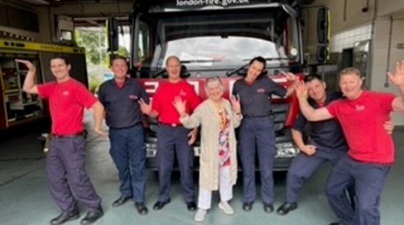 Group of seven people at a fire station 