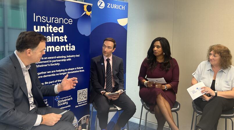 Two men and two women sat on stools having a discussion