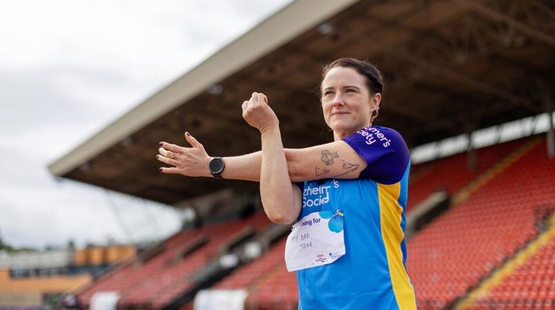 Woman outside at a stadium training for the Dementia Run Club