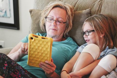 Grandma and daughter looking at an iPad