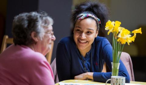 An older woman and young care home worker