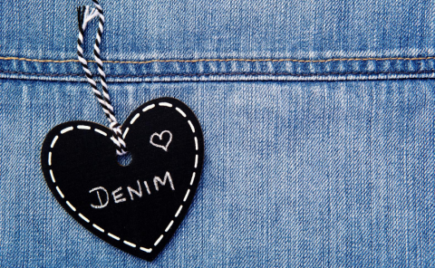 Black heart hanging on denim jeans with the word Denim written
