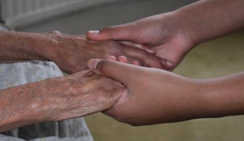 A'yaan holding his grandmother's hands