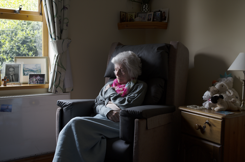 A woman sitting in a care home