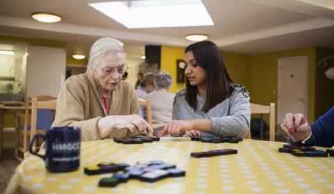 Two women in a care home playing a game