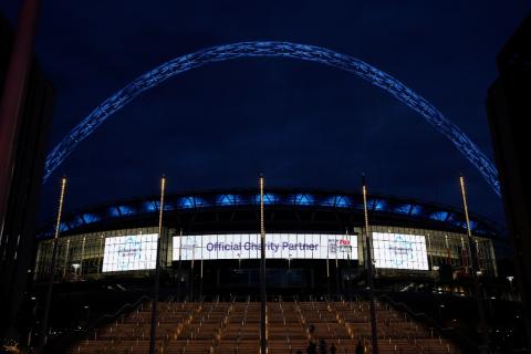 Wembley stadium lit up with the Alzheimer's Society logo