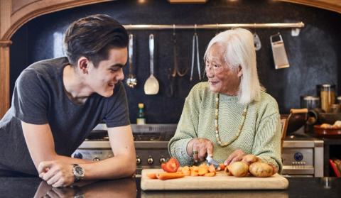 Annie Chinfen preparing food with her grandson