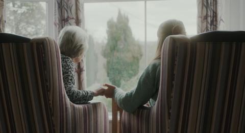 Saskia and Teresa holding hands in Teresa's care home