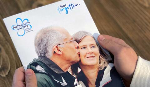 Two hands holding a copy of the Will guide